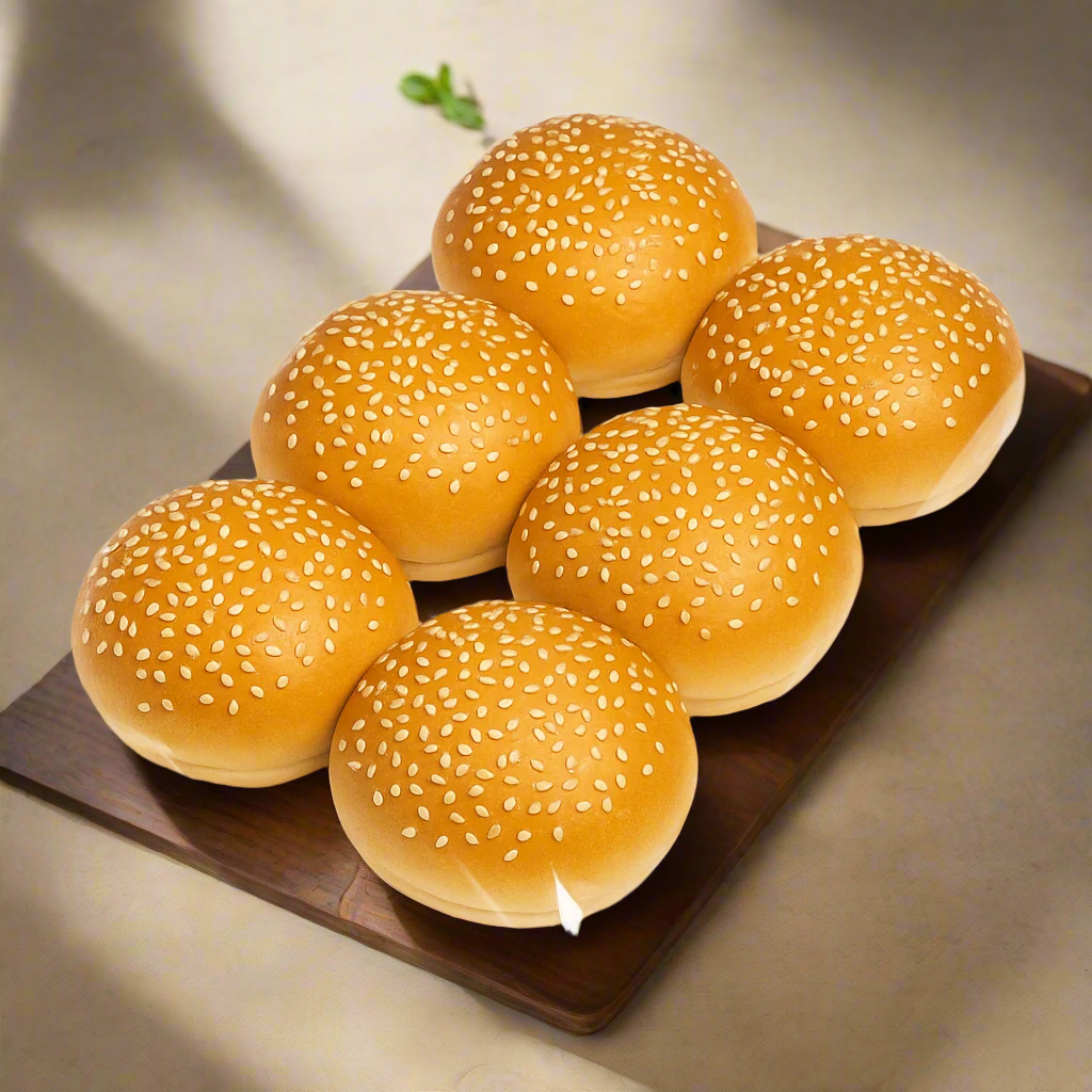 Six sesame seed buns on a white background